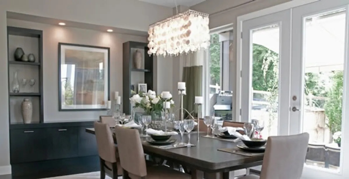 Elegant dining room chandelier installation above table in Fort Lauderdale, FL