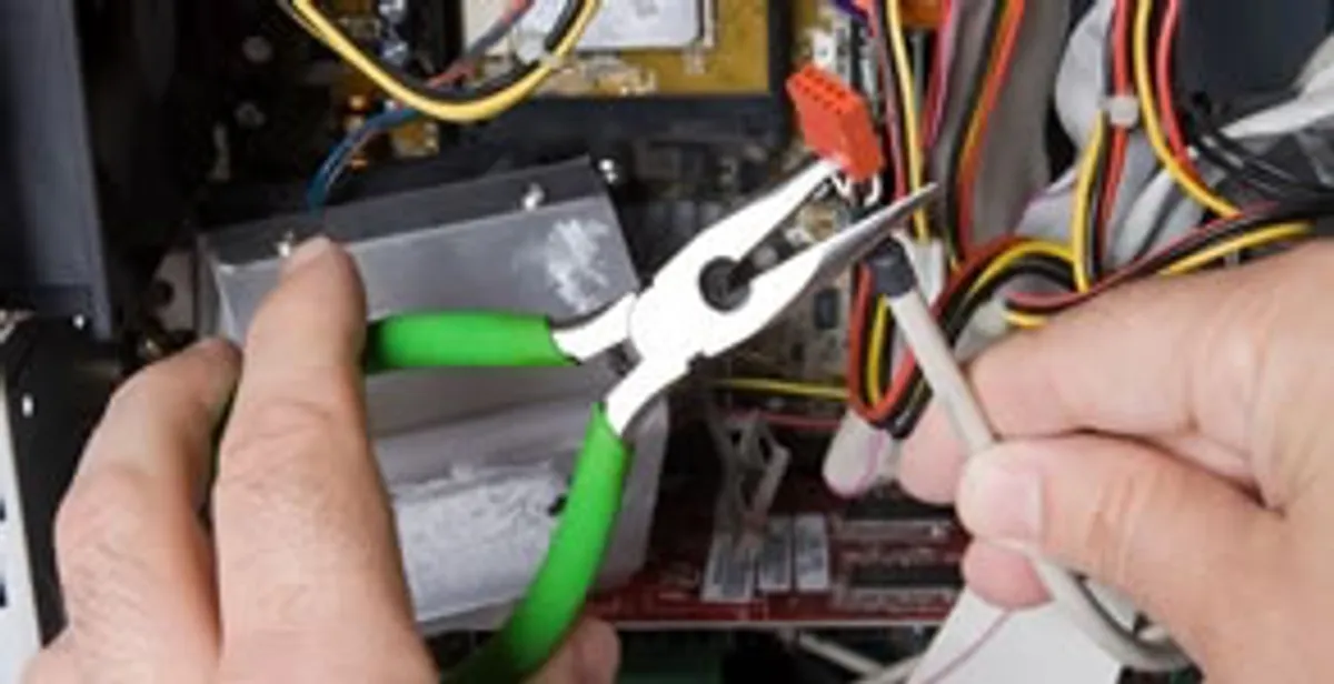 Licensed electrical contractor performing electrical repair with tools in Pompano Beach, FL