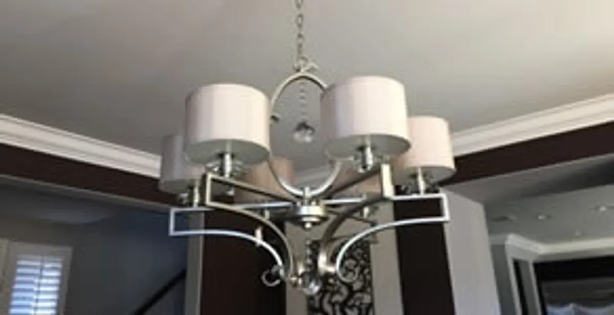 Modern chandelier installation with multiple light fixtures in Fort Lauderdale, FL